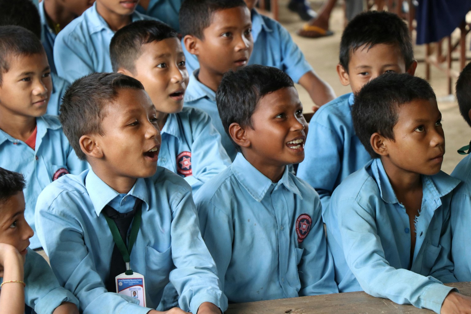 Boys in classroom laughing together